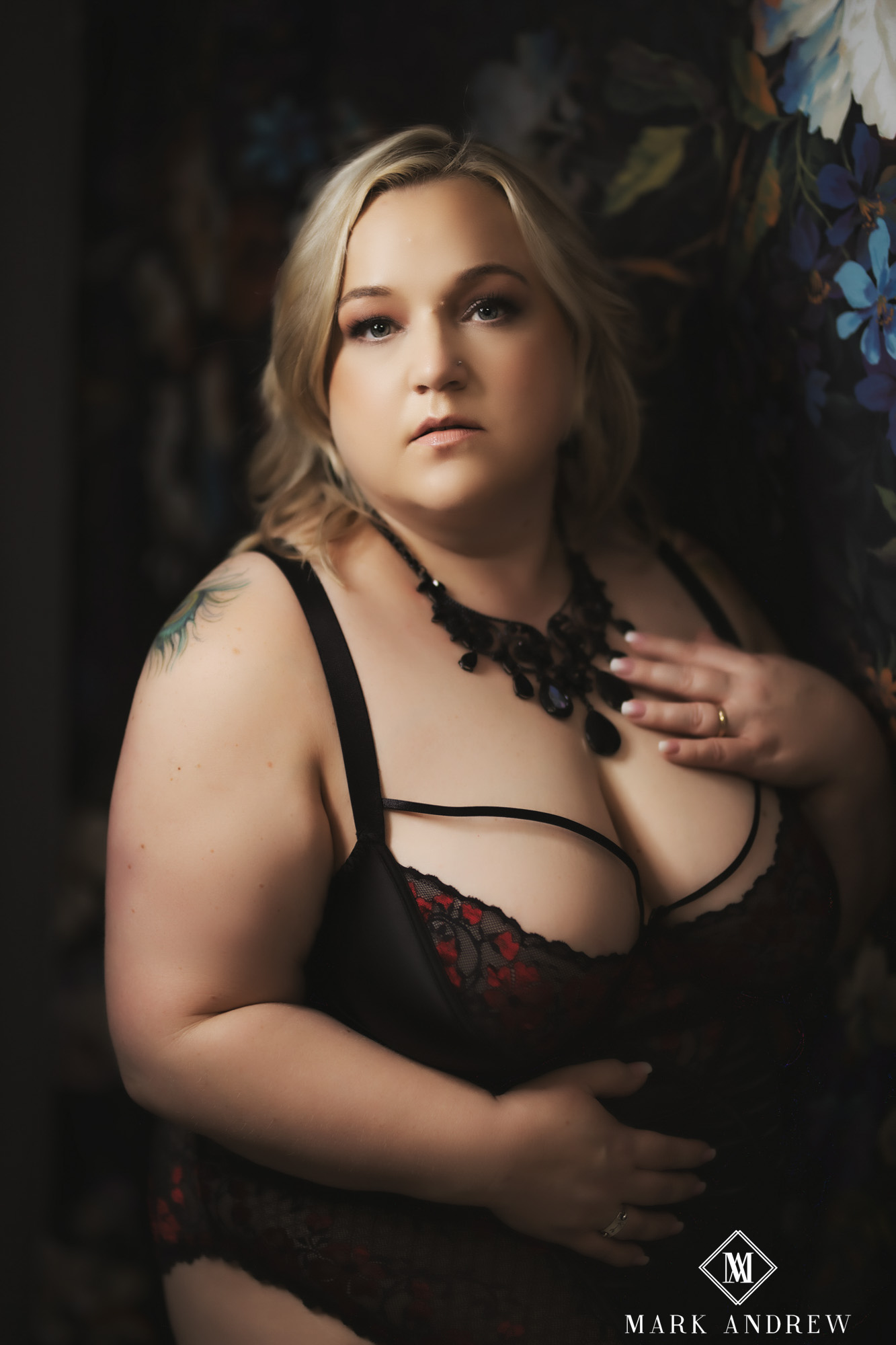 Becky in black and red lace lingerie against a painted floral backdrop — luxury boudoir portrait, Granger Indiana studio