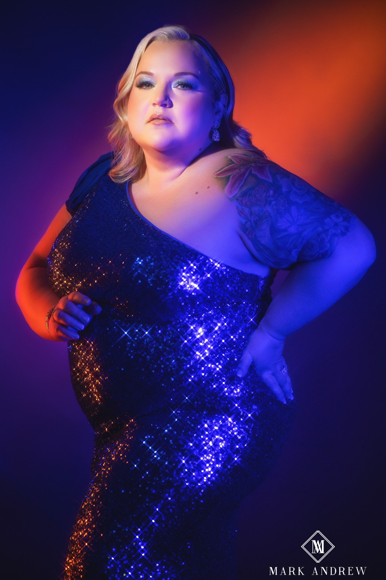 Becky in a blue sequin gown under split orange and blue stage lighting — Project 33 glamour portrait, Mishawaka Indiana studio
