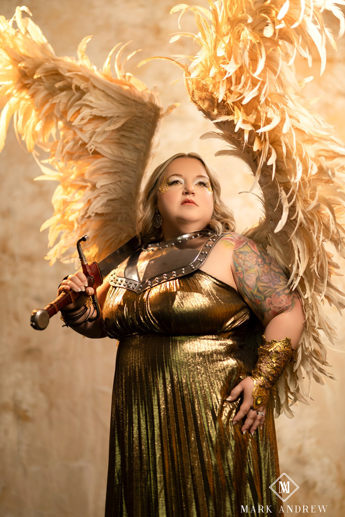 Becky as a warrior angel — gold wings, gold dress, sword in hand — themed boudoir portrait, South Bend Indiana