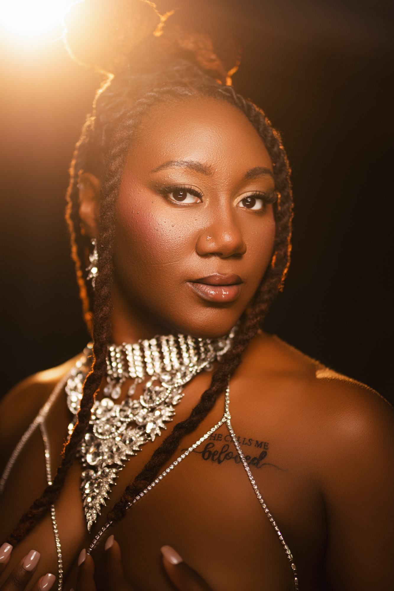 Boudoir client in crystal body chain in golden light