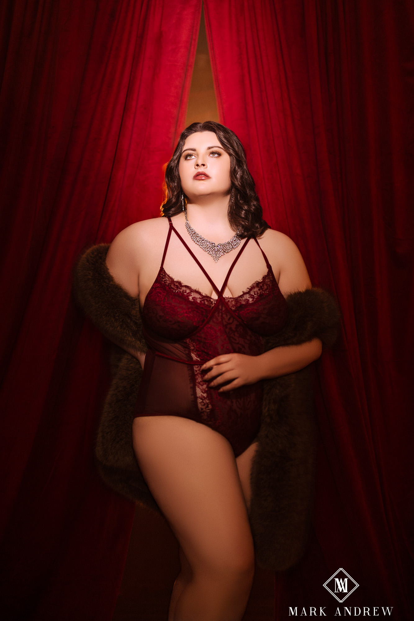 Katherine in a wine-red lace bodysuit with a fur coat between red velvet curtains — Set 2, the stage