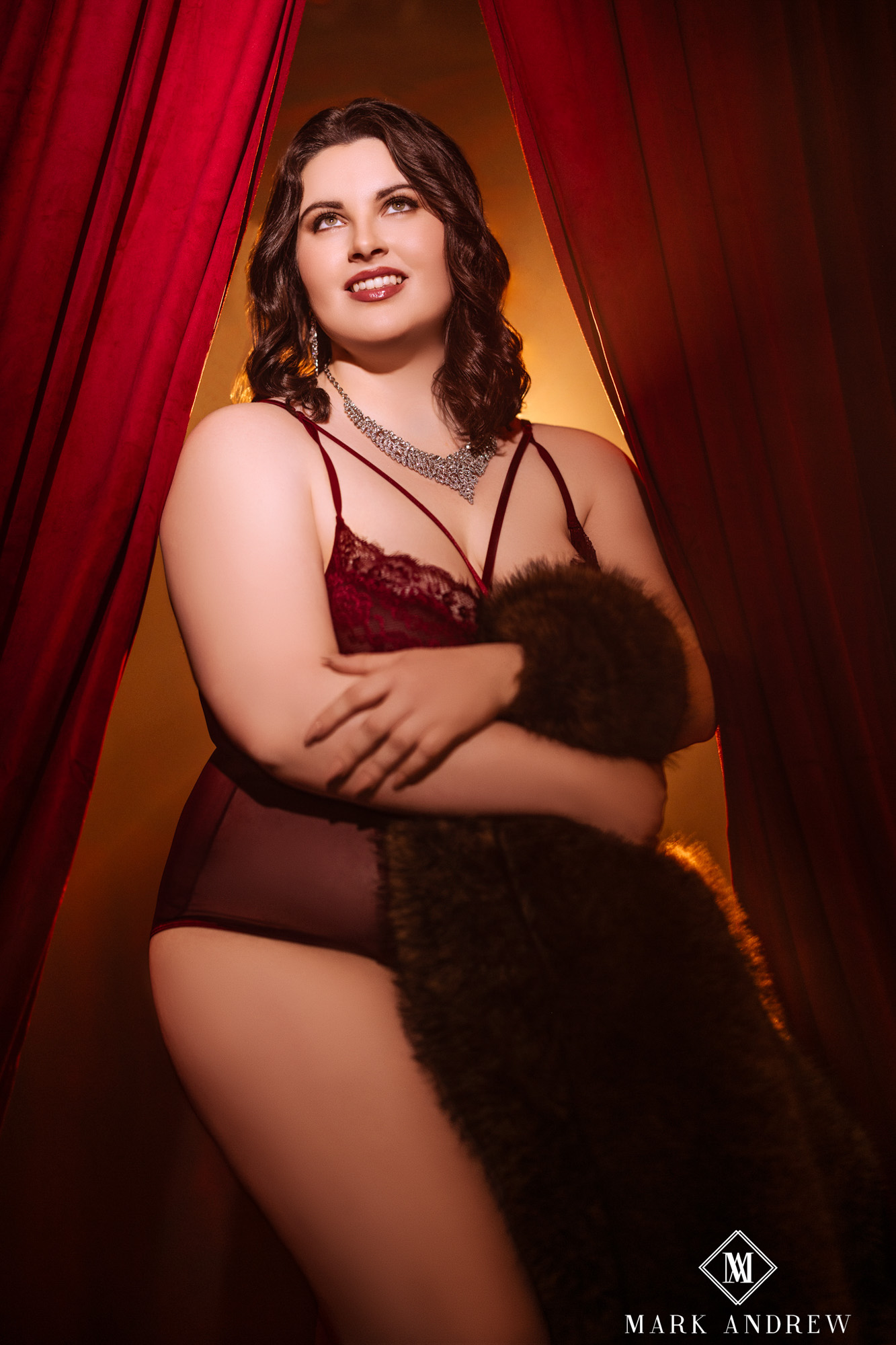 Katherine in Set 2 — red velvet curtains and dramatic lighting