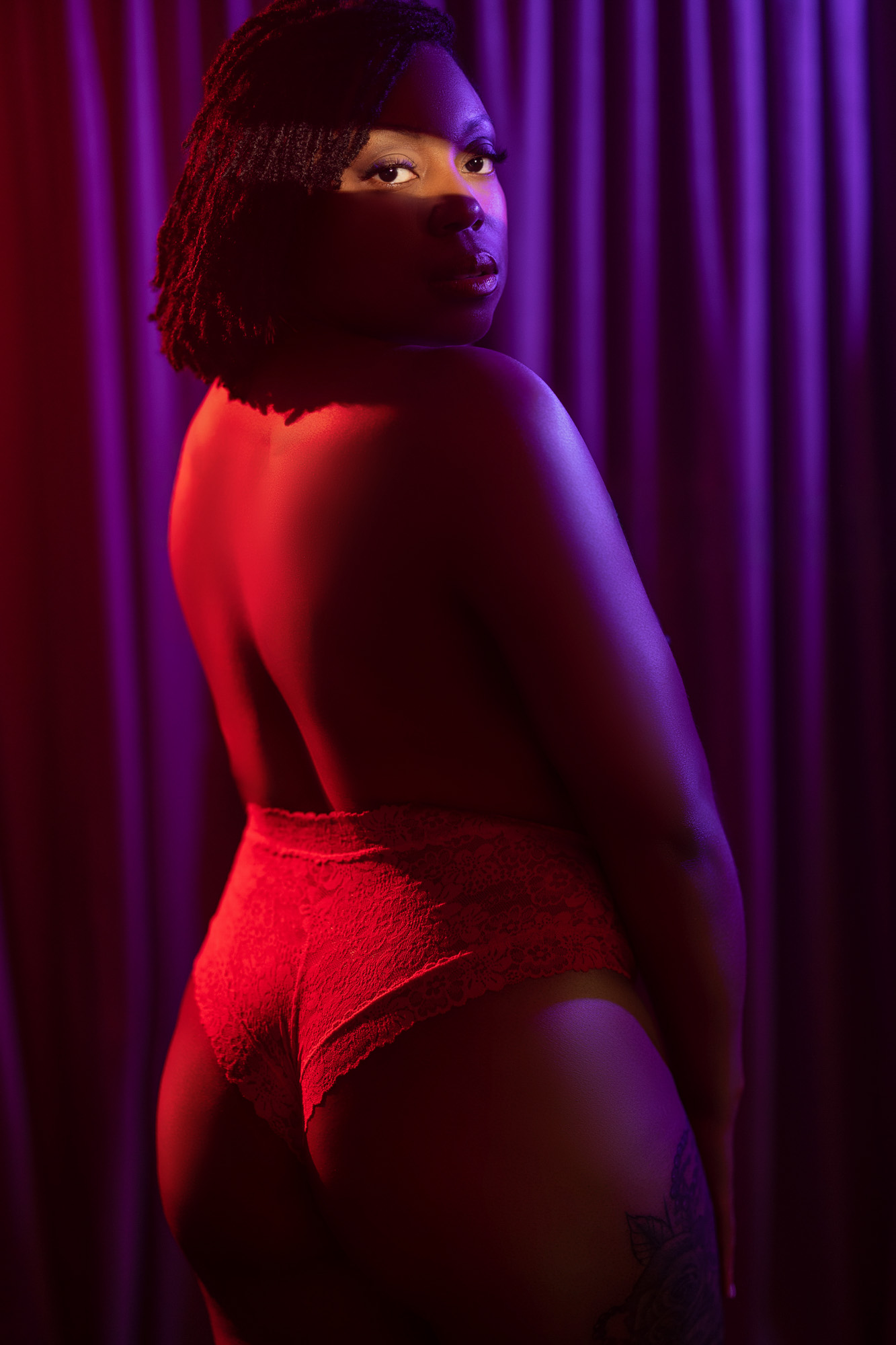 Boudoir client in red lace cheeky panties from behind